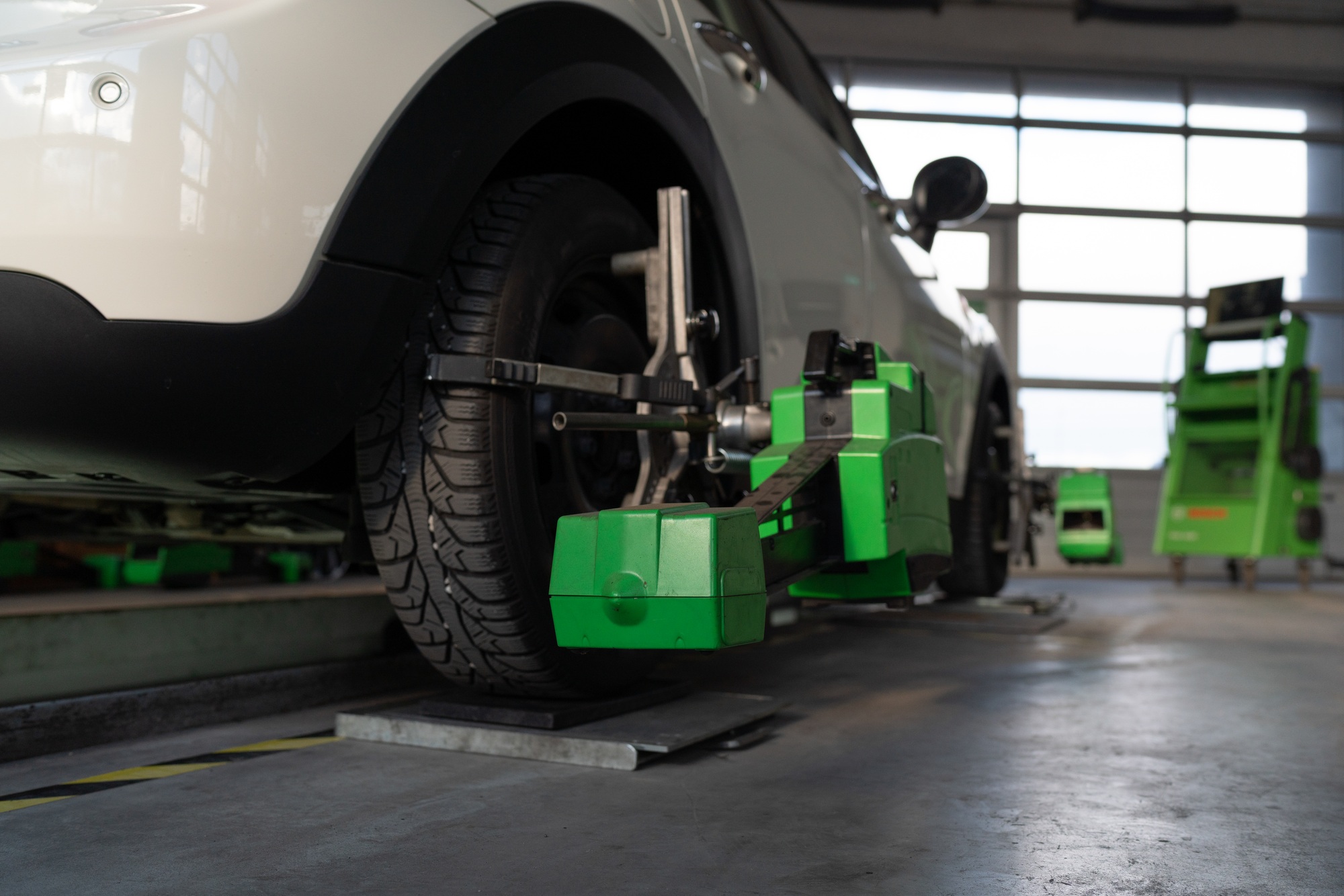 Wheel alignment of car wheels at car repair